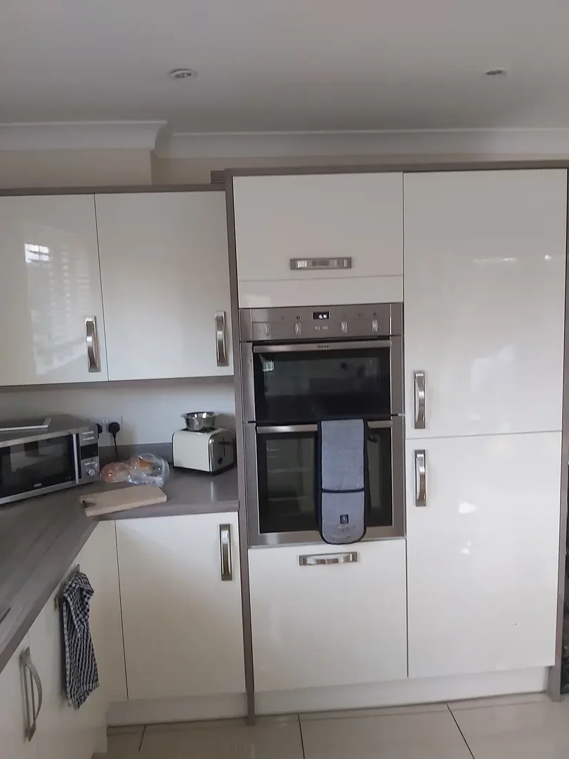 White fitted kitchen cabinetry with integrated appliances