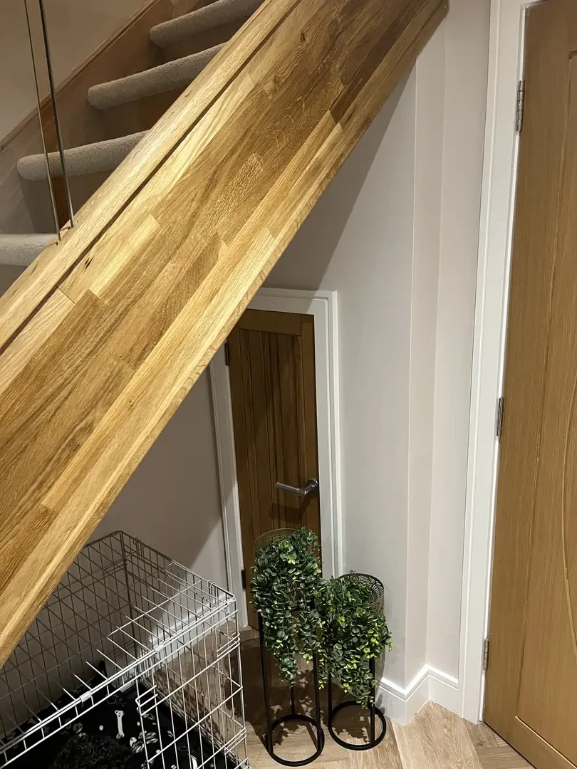 Close view of a finished oak staircase handrail