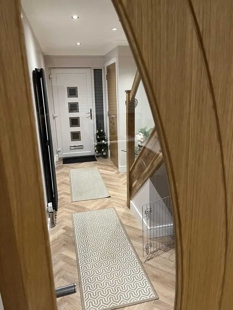 Completed hallway joinery with oak staircase and glass balustrade