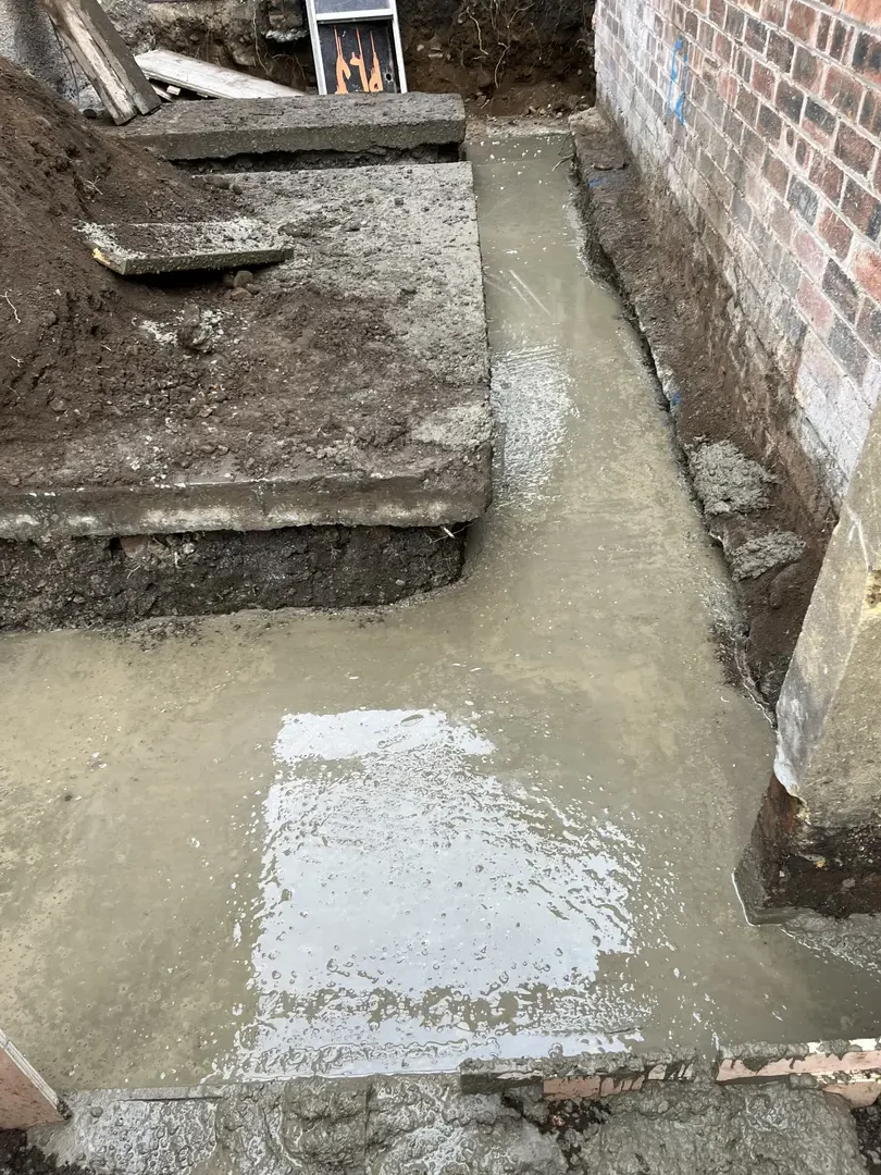 Concrete foundations prepared beside an existing property