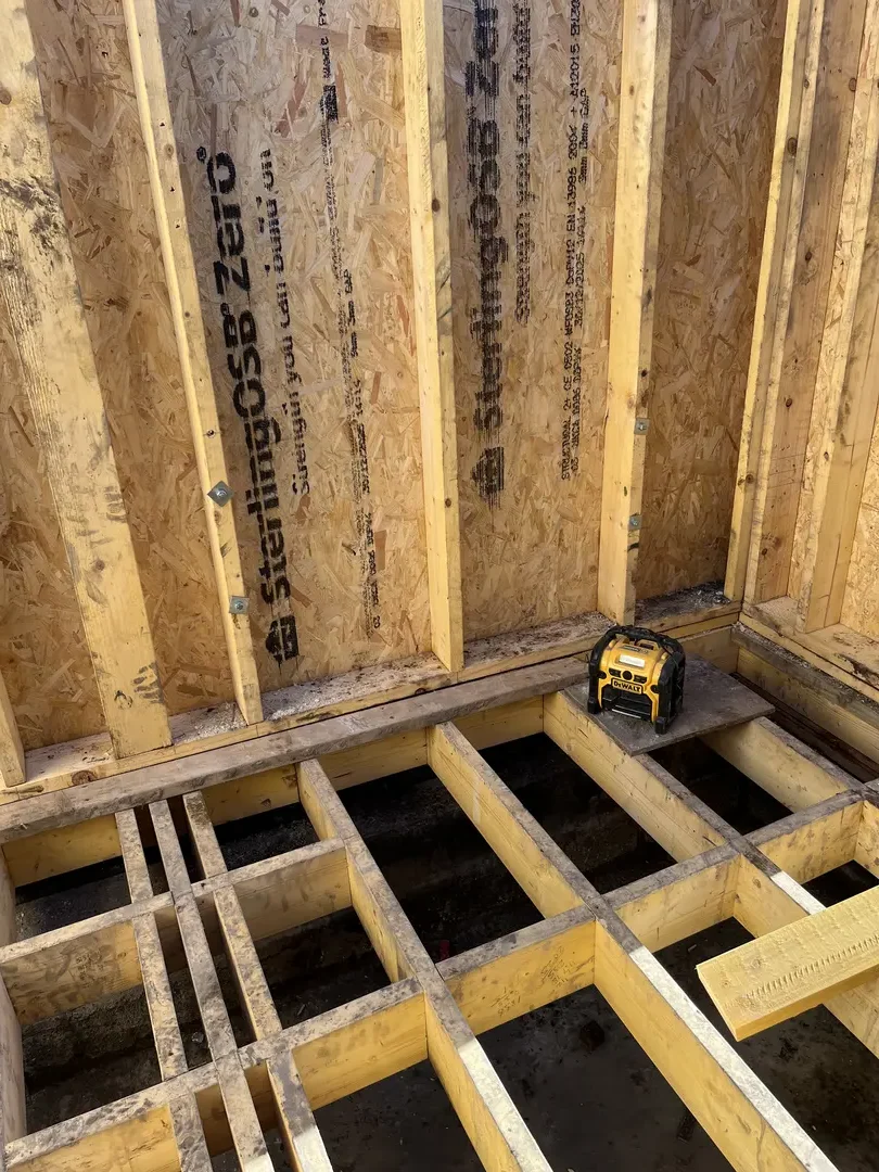 Insulated timber floor joists with service routes under construction